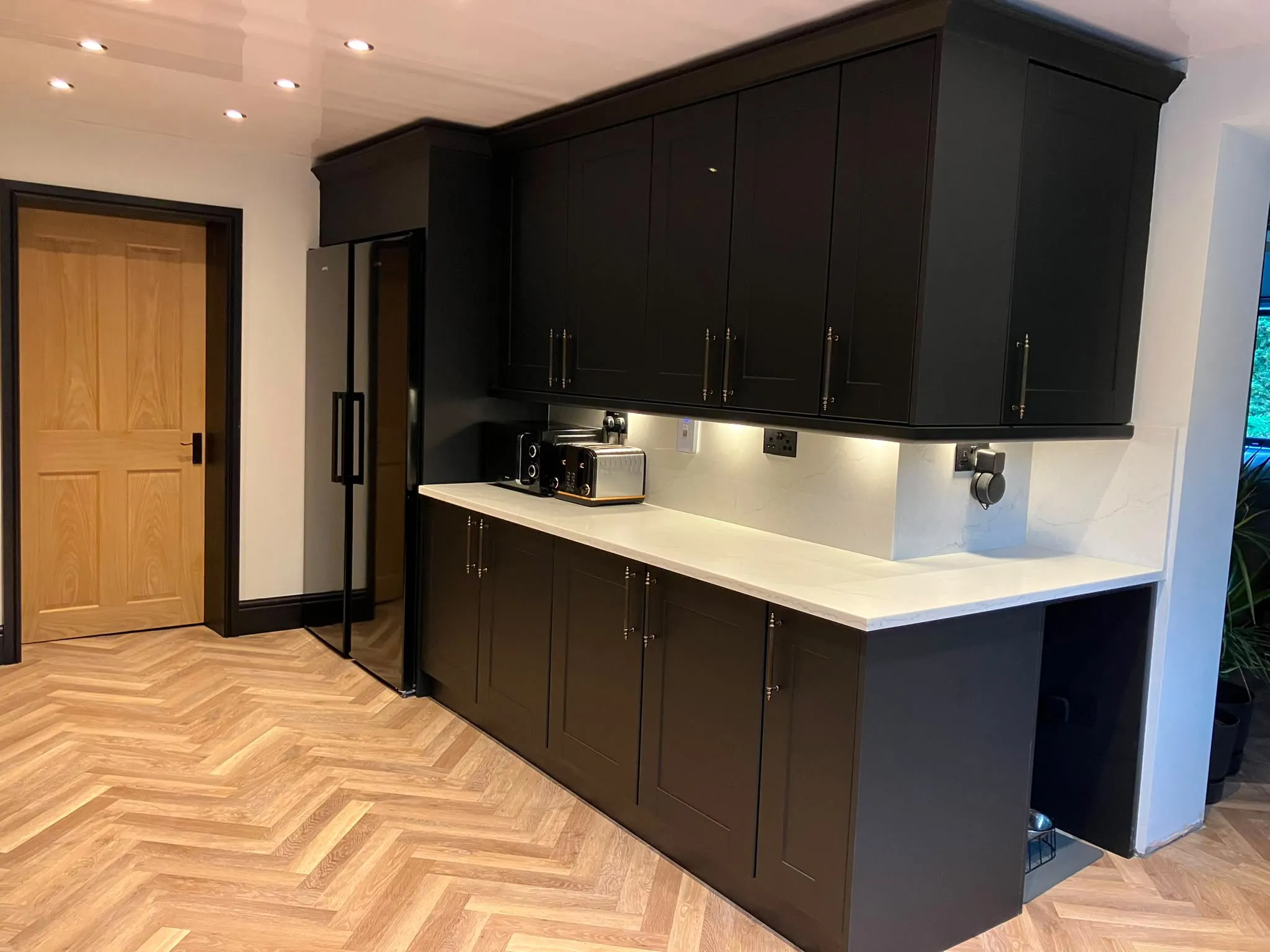 Matte black fitted kitchen units with integrated coffee machine by LDG Joinery LTD, Bolton